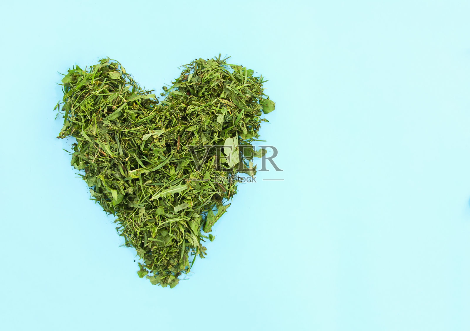 绿色的心，用新鲜的草做成。照片摄影图片