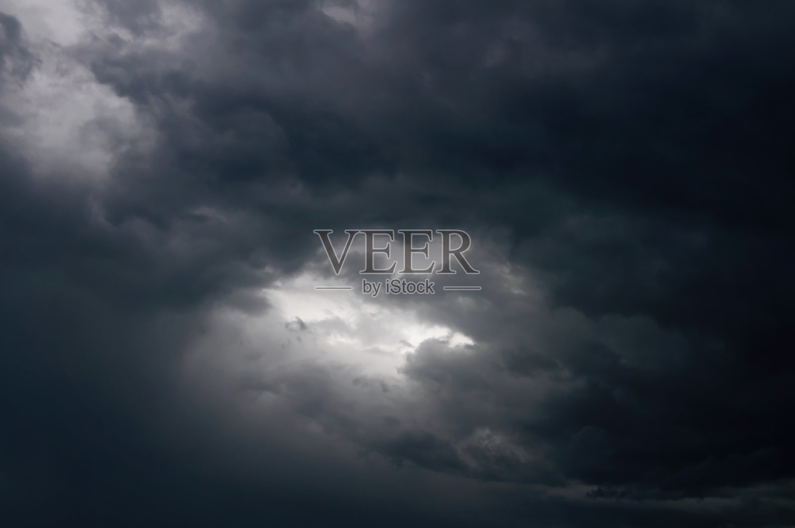 雷雨前乌云密布。暴风雨前乌云中的一丝微光。照片摄影图片
