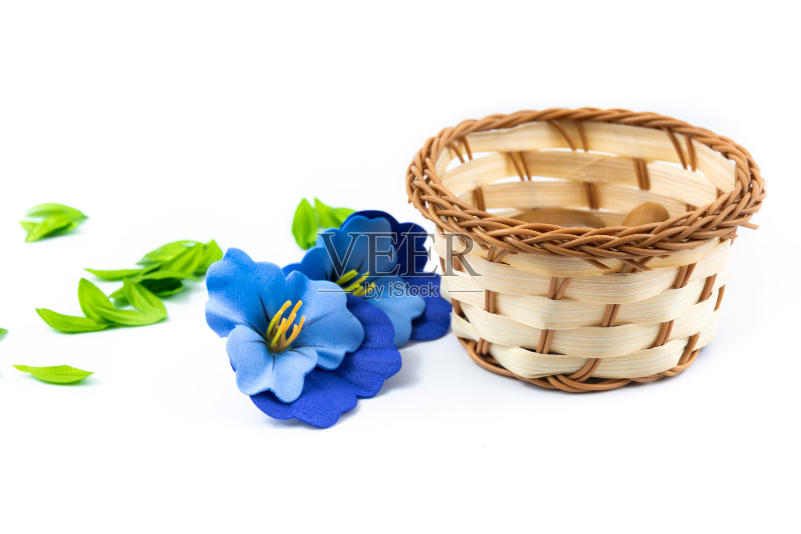 柳条篮子和植物组成蓝色的花，花瓣，在白色孤立的背景上照片摄影图片