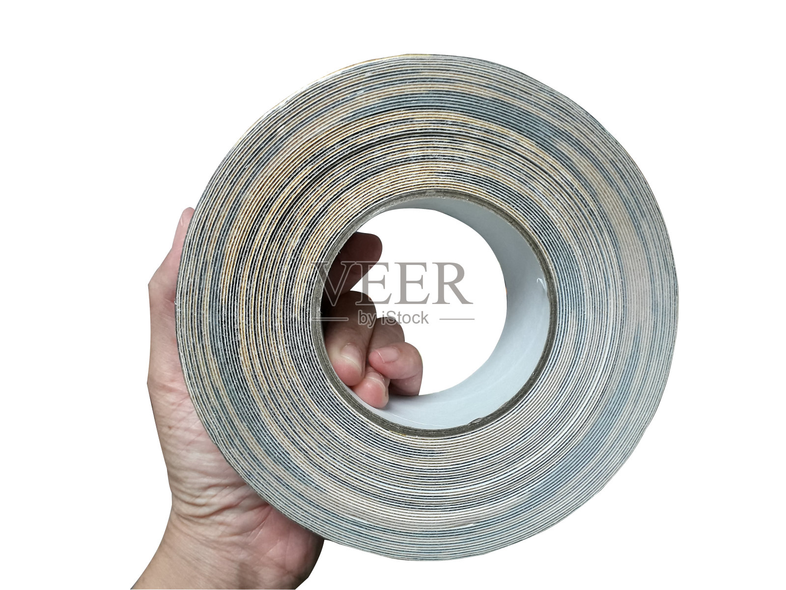 手上拿着一卷黑色胶带。照片摄影图片