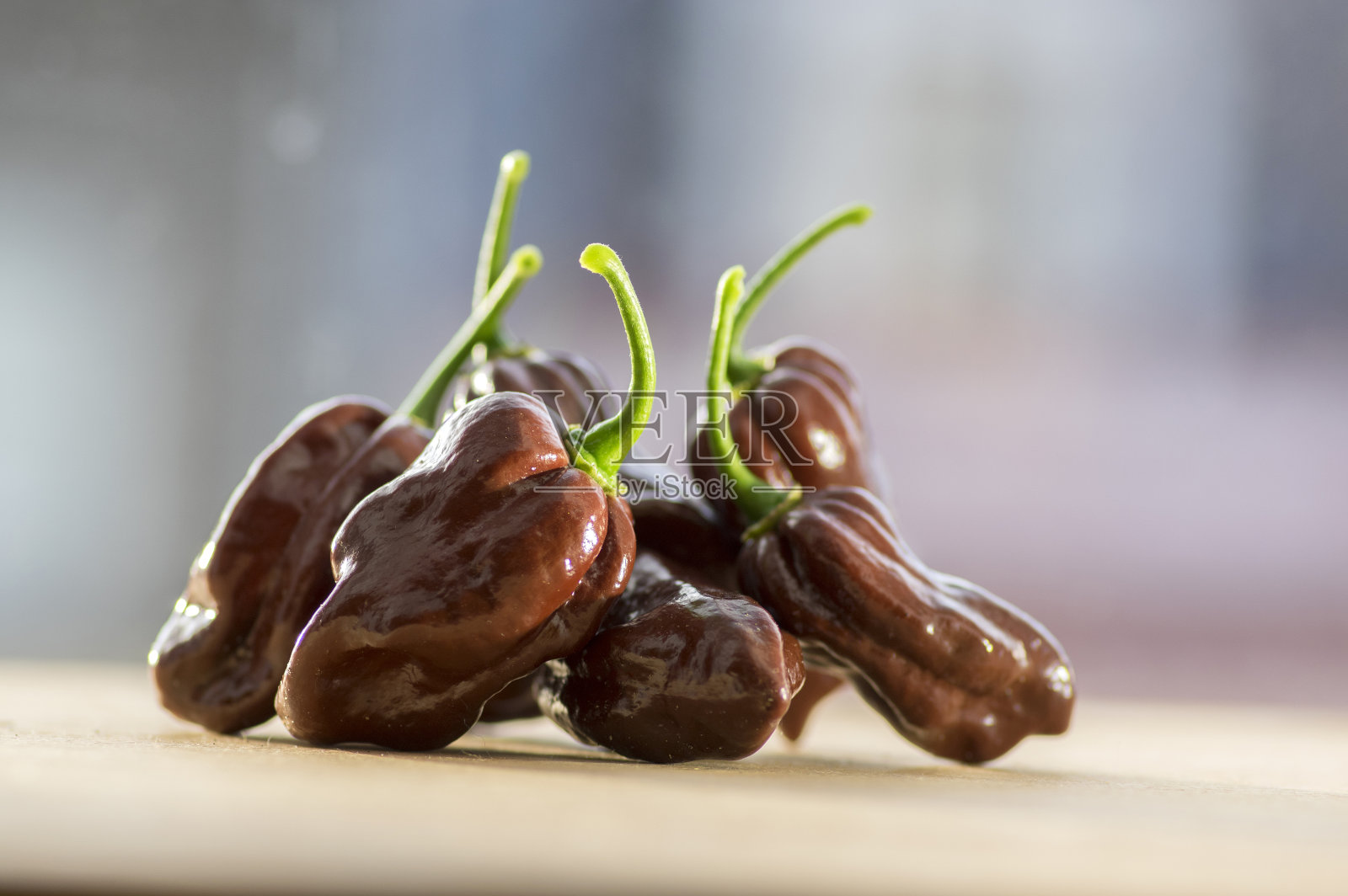 木桌上有一组熟辣椒，很辣的辣椒，哈瓦那巧克力照片摄影图片