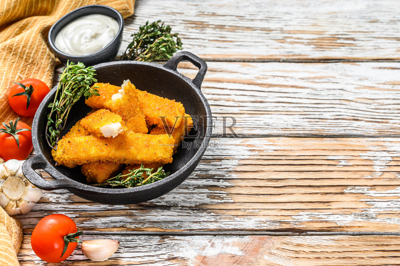 脆皮鱼条配面包屑，配酱塔塔在平底锅中享用。白色背景。前视图。副本的空间。照片摄影图片