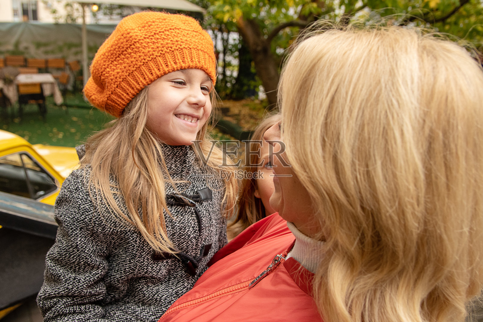穿着秋装的女人和可爱的小女孩玩得很开心。妈妈，小女儿在花园外面。母亲节爱家庭，为人父母童年观念。照片照片摄影图片