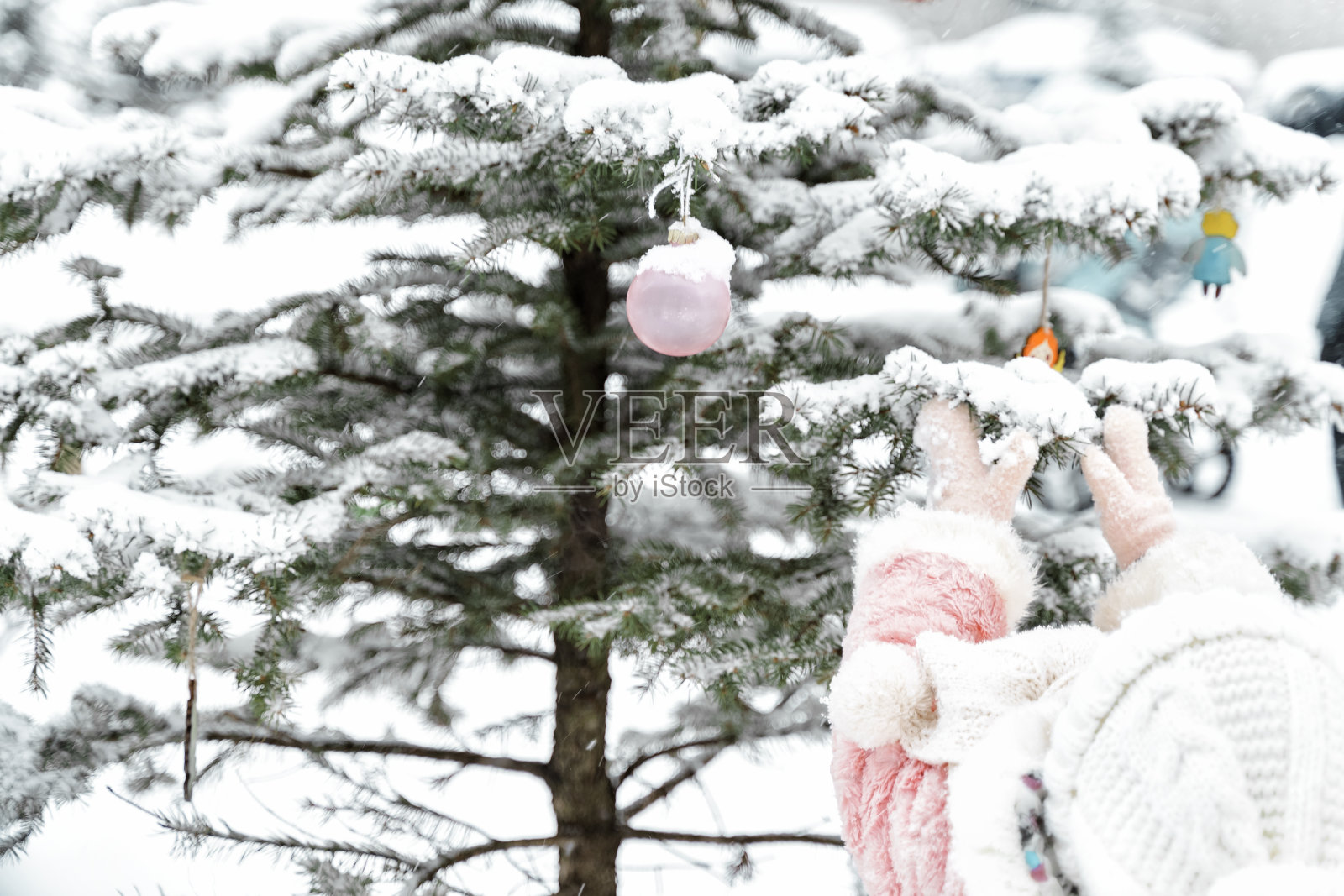 小女孩在房子的院子里装饰圣诞树照片摄影图片