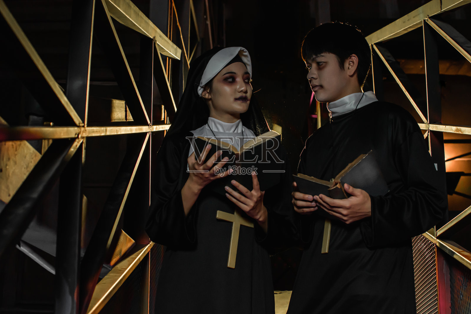 尼姑和神父在万圣节之夜的肖像照片摄影图片