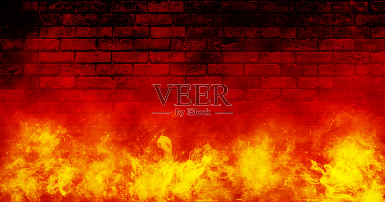 橙色的火或火焰与火花和烟在红砖的背景。照片摄影图片