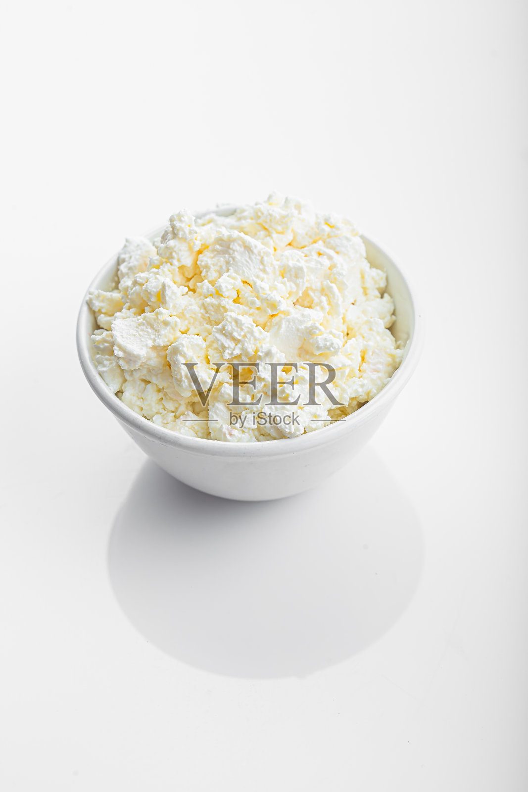 在一个白色的盘子里，在孤立的白色背景上放置易碎的白干酪照片摄影图片