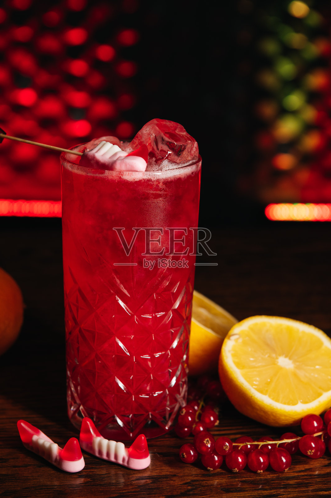 万圣节水果鸡尾酒与百香果，柠檬，南瓜和红醋栗在餐厅的桌上照片摄影图片