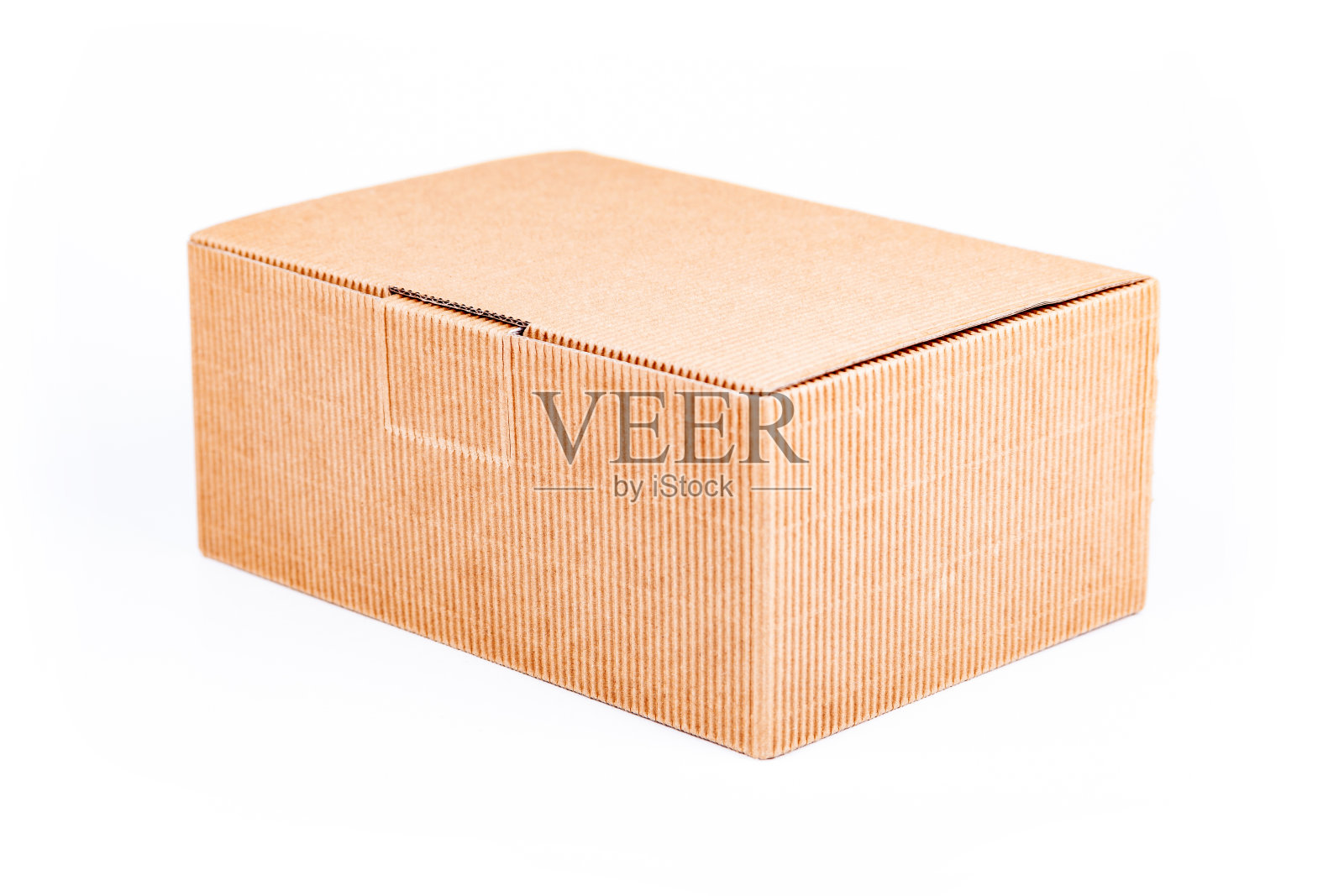 简单的单一小棕色瓦楞纸箱投递箱盖封闭隔离在白色背景上，物体切割，特写。运输、包装、仓储概念照片摄影图片