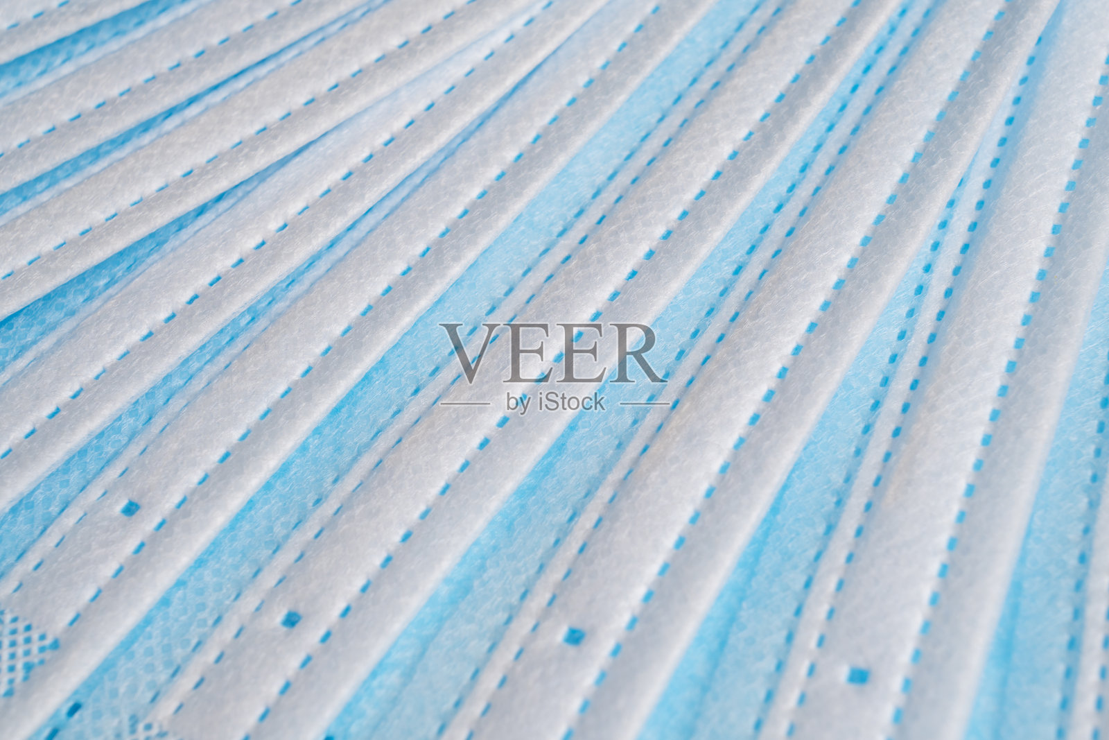 一堆医用口罩微距拍摄保护口罩图案。医疗保健和医疗理念。防护口罩或医用口罩。医用防护屏蔽绷带背景照片摄影图片