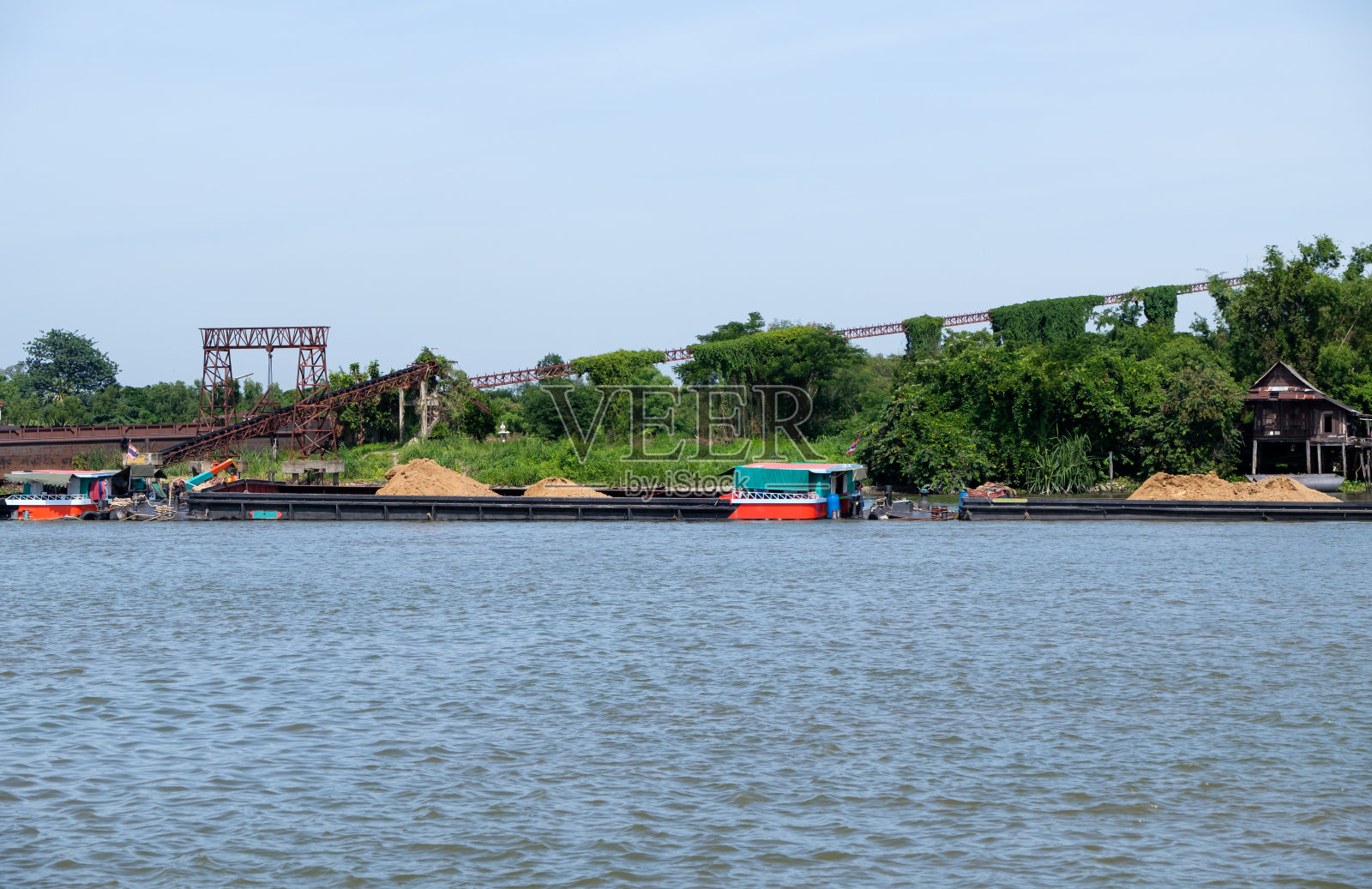 这艘大型货船正在装沙准备运输。照片摄影图片