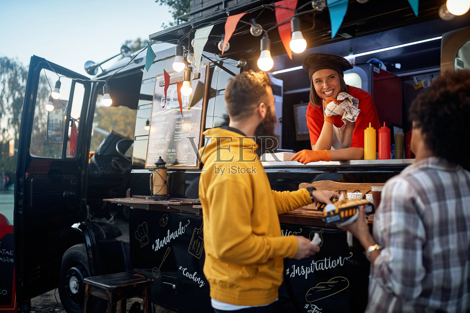 朋友们在快餐店前吃饭，和女员工聊天照片摄影图片