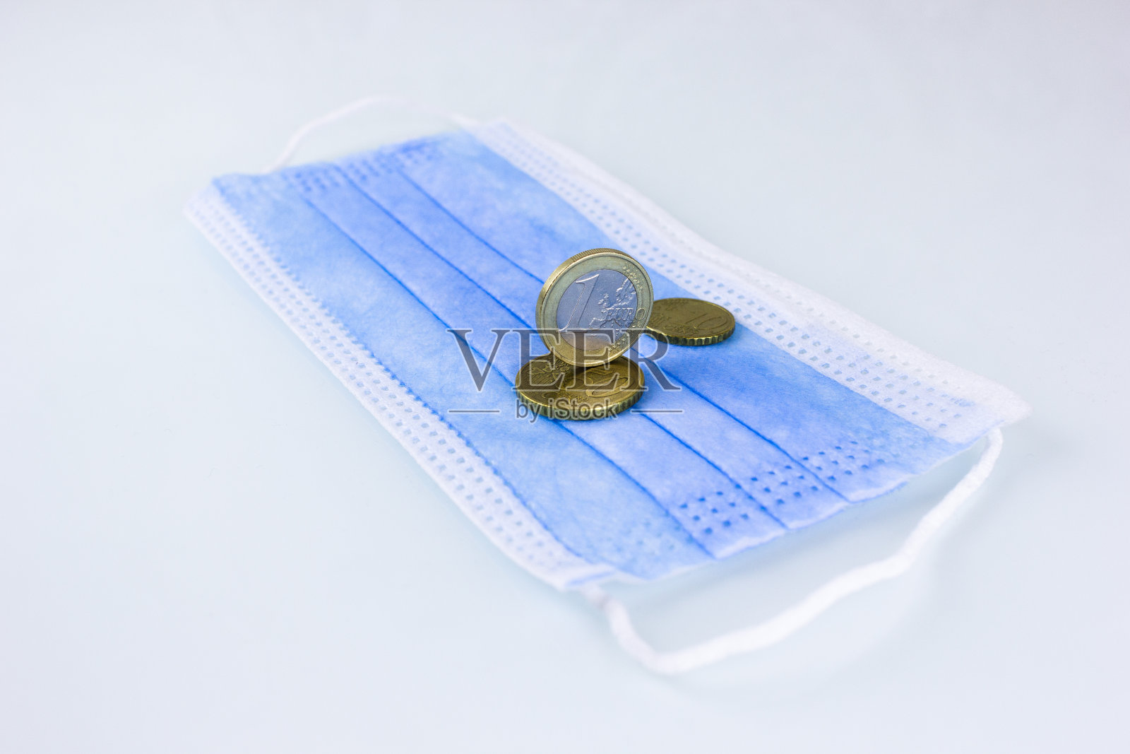 硬币在医用口罩上照片摄影图片