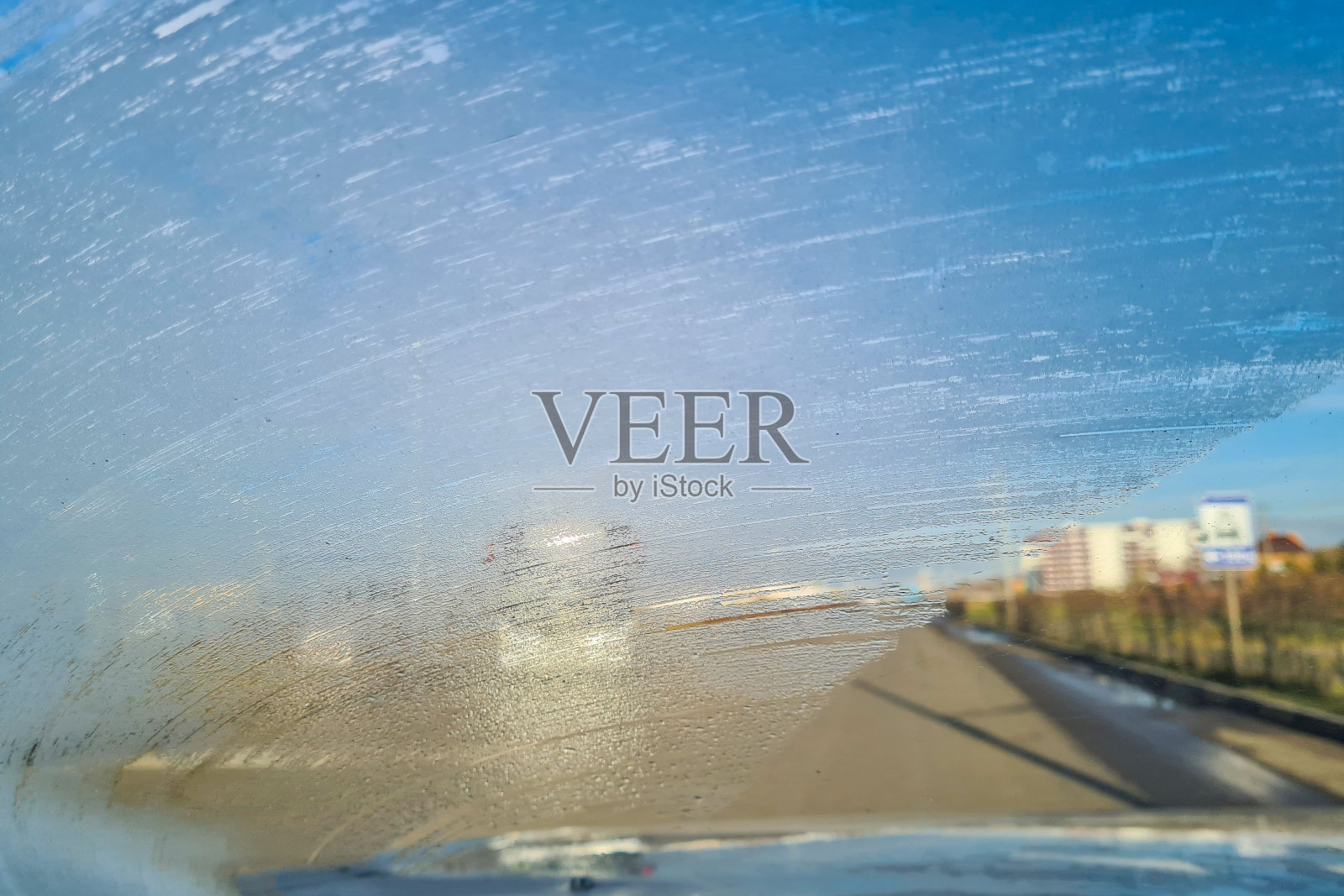 在高速公路上开车时挡风玻璃上结了霜。能见度差，前背景模糊，散景效果下的驾驶危险照片摄影图片