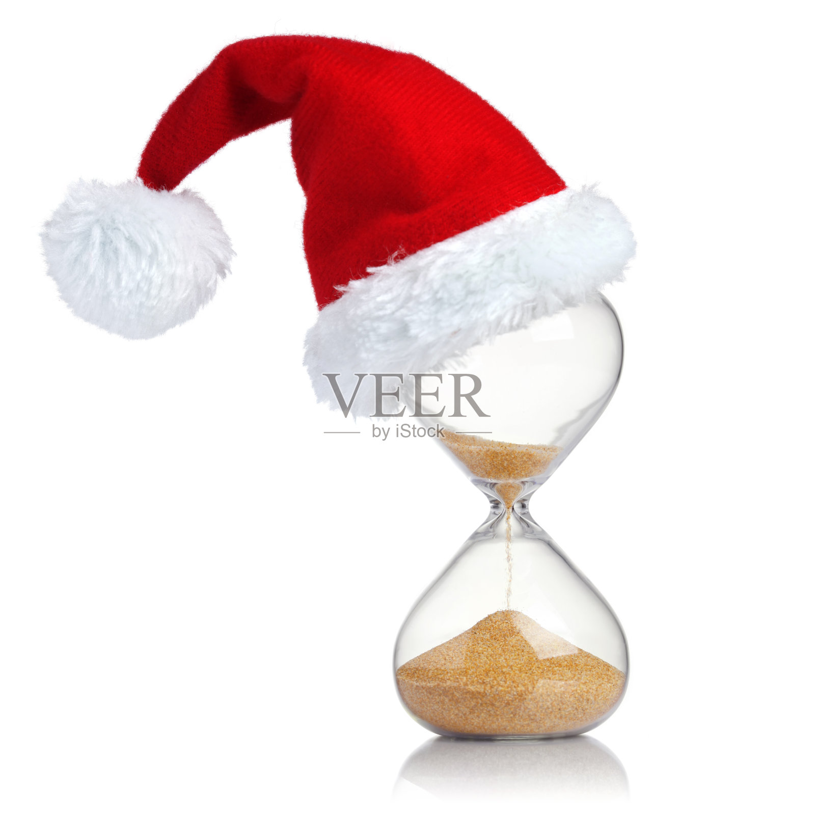 沙漏与圣诞老人的帽子显示时间的流逝照片摄影图片
