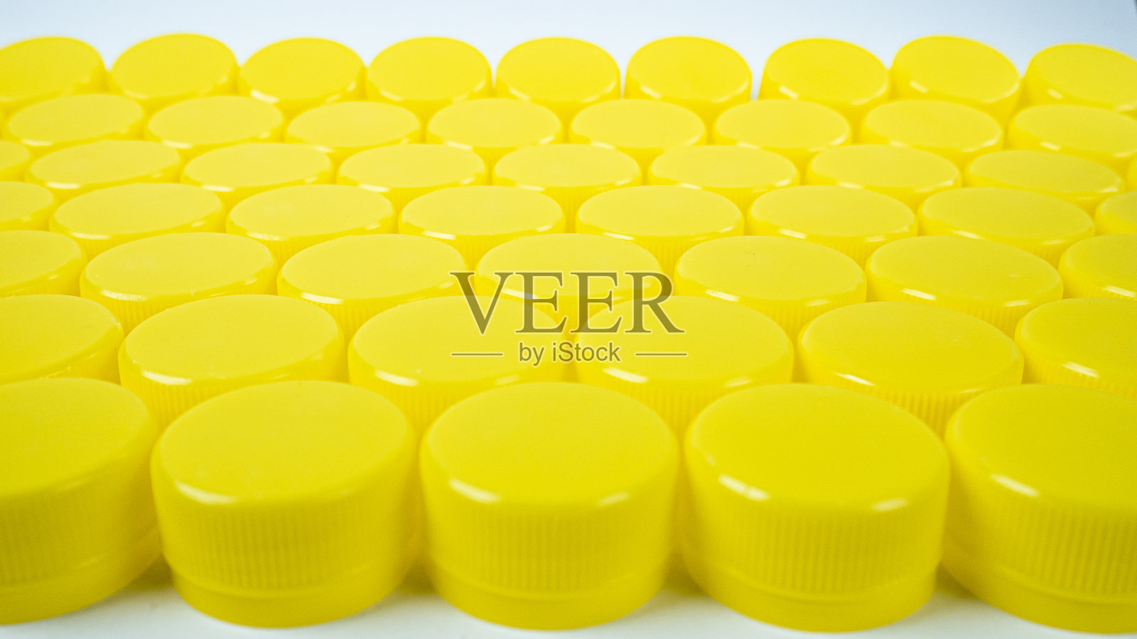 黄色塑料瓶盖自我背景。照片摄影图片