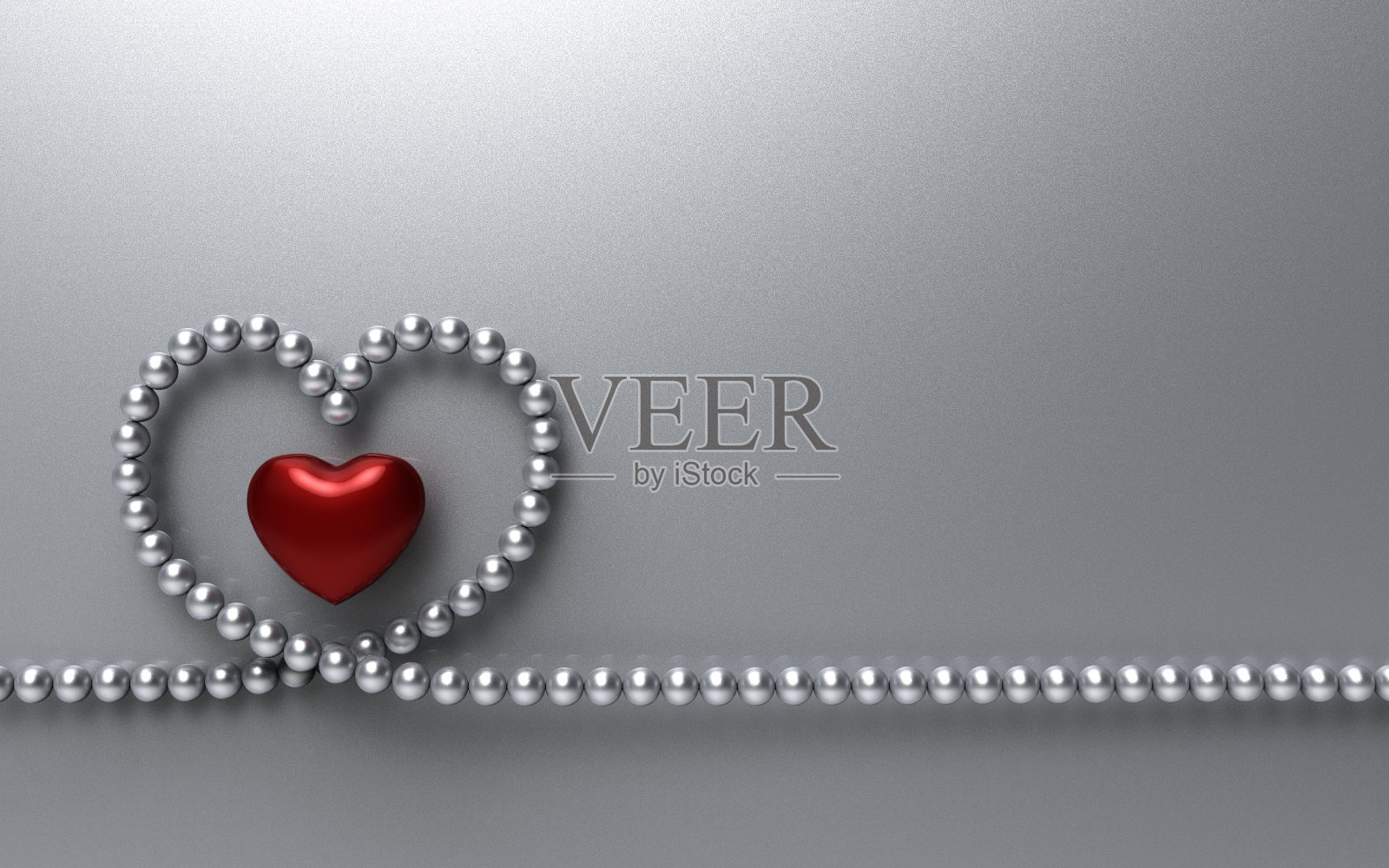 银色背景上镶着银色珠子的红心照片摄影图片