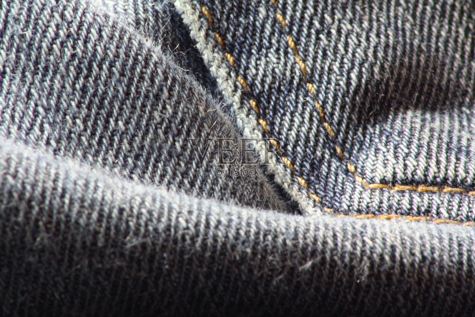 照片接近细节的旧蓝色牛仔裤和纹理牛仔裤。照片摄影图片