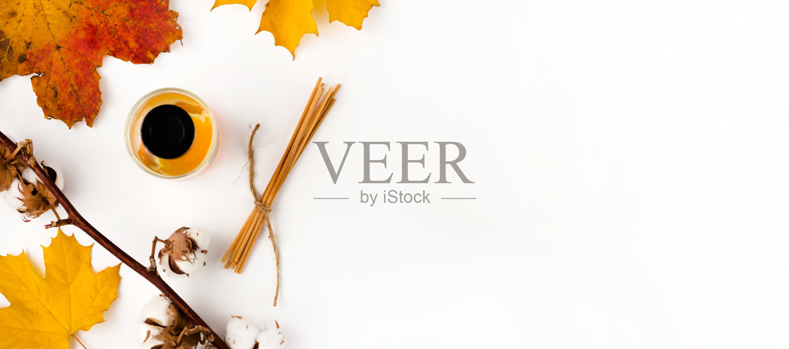 秋天的氛围构成。空白贺卡模型。香水瓶，五颜六色的枫叶。白色背景。平躺，俯视图。照片摄影图片