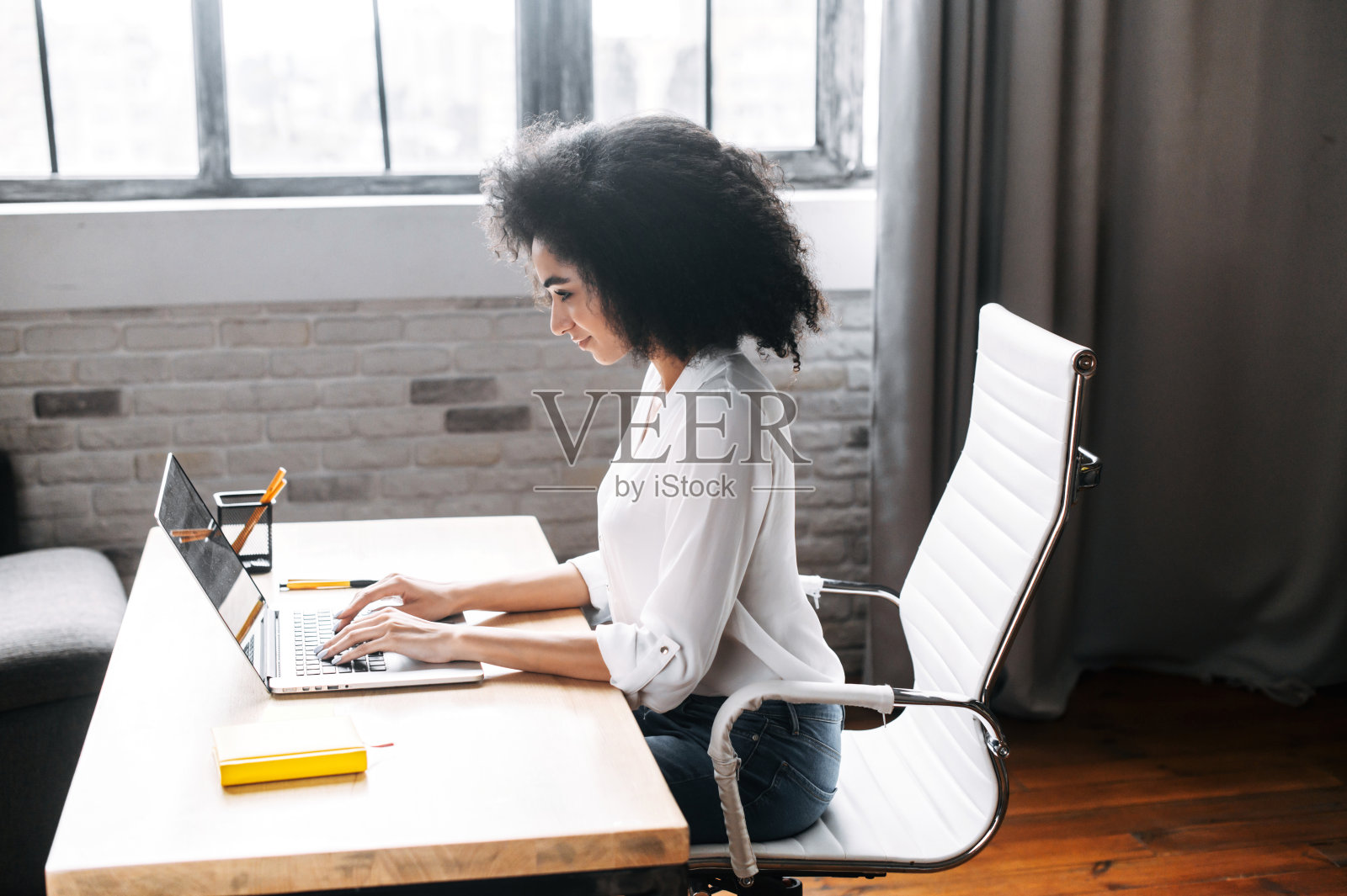 一位年轻女士正在办公室使用笔记本电脑照片摄影图片