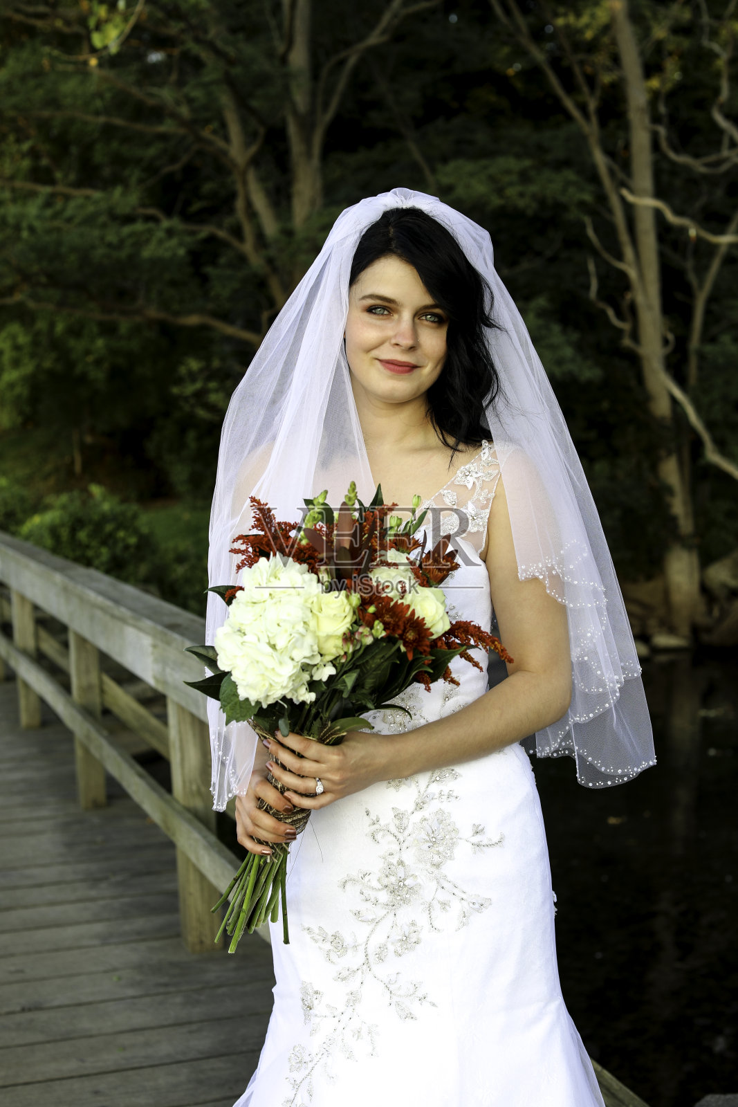 穿着白色婚纱和面纱的美丽新娘照片摄影图片