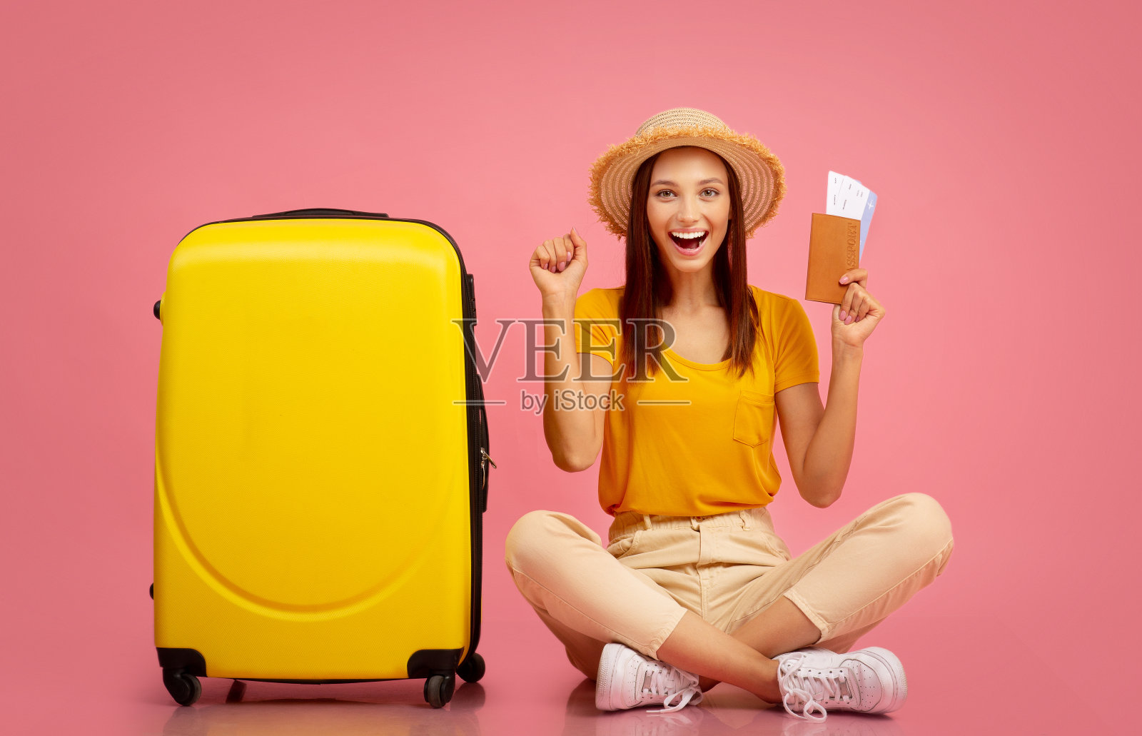 拿着护照的年轻女子举起拳头照片摄影图片