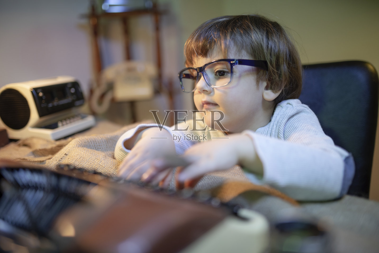 在桌子上工作的滑稽男孩照片摄影图片