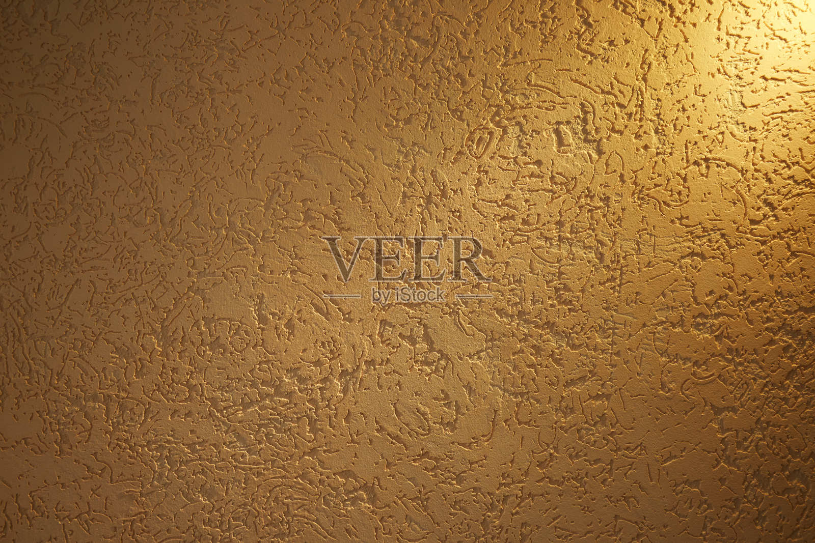 柔和的黄色光线落在带有图案的纹理背景上照片摄影图片