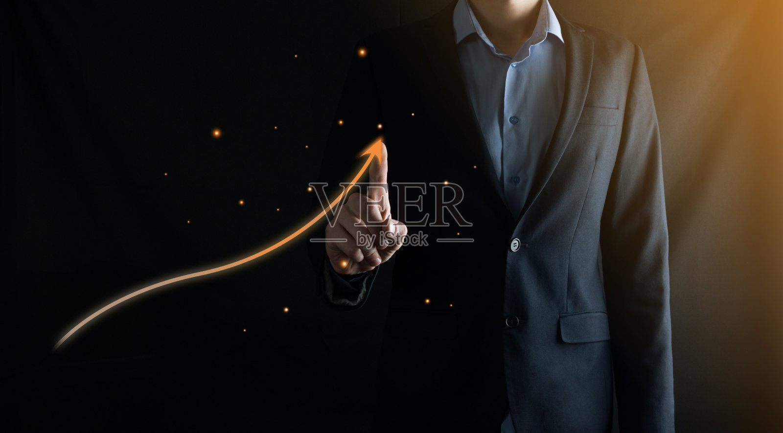 西装商人用手指在黑色的背景上画了一个向上的箭头。金融发展的概念照片摄影图片