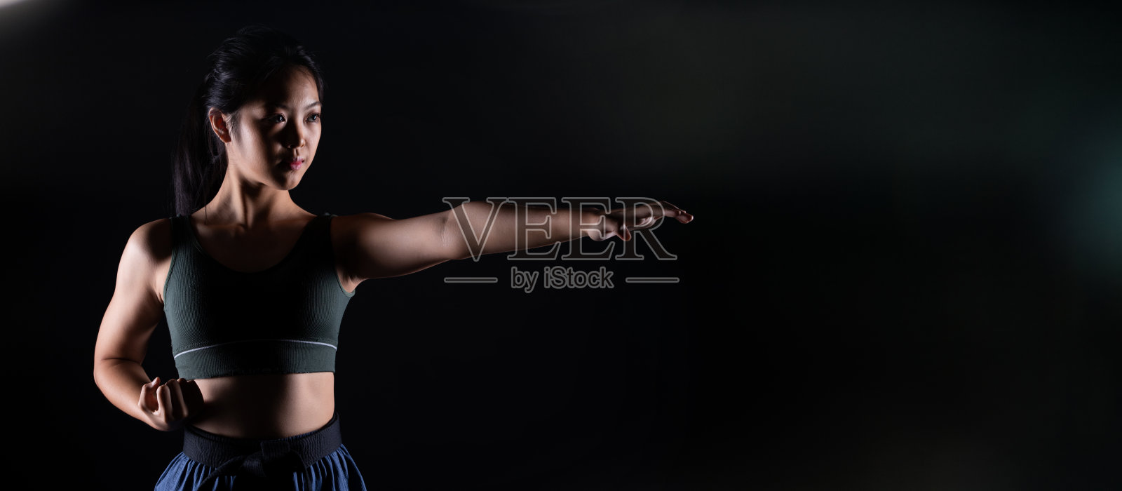 跆拳道空手道少年运动员踢出拳黑色背景孤立照片摄影图片