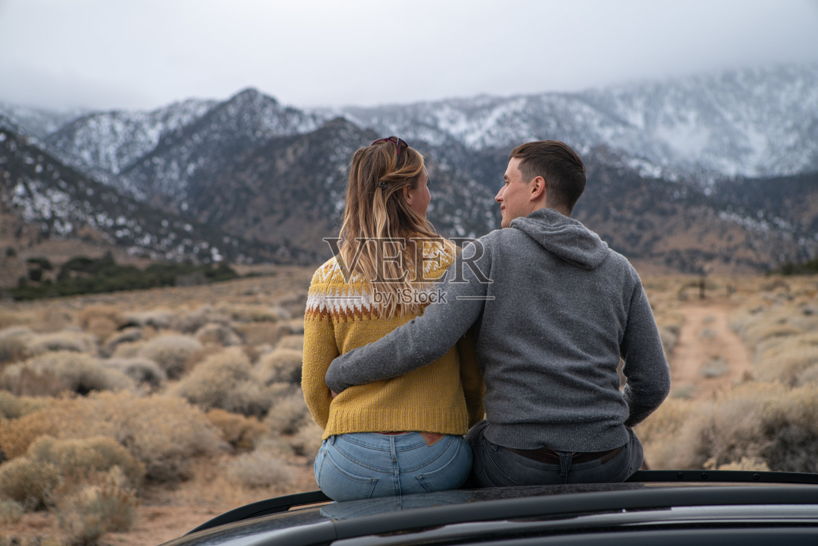在车顶上欣赏山景的情侣照片摄影图片
