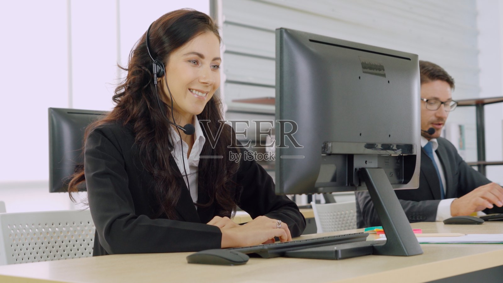 商务人员戴着耳机在办公室工作照片摄影图片