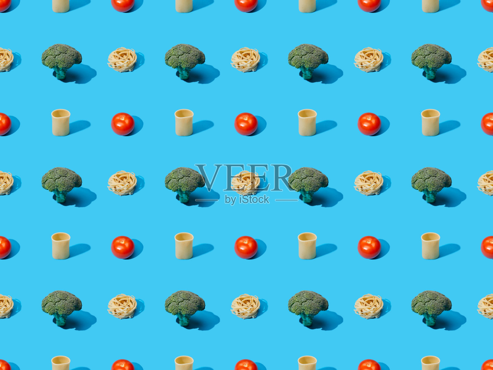 新鲜意面与西兰花和西红柿在蓝色背景，无缝模式照片摄影图片