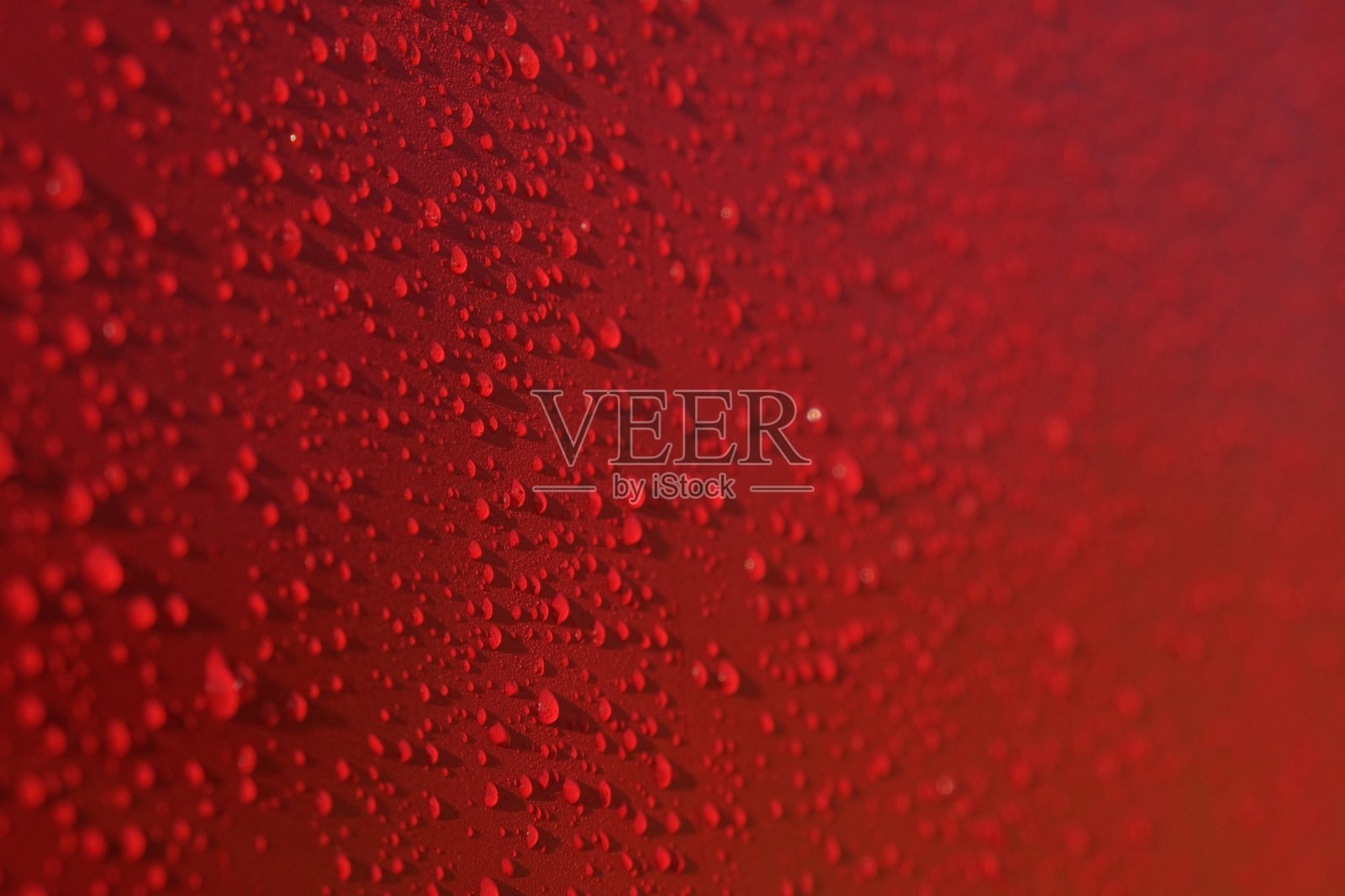 水滴图案的红色背景。果汁飞溅。红色多汁的表面滴，任何用途的伟大设计。纹理背景,模式。夏天明亮的背景。明亮温馨的颜色。照片摄影图片