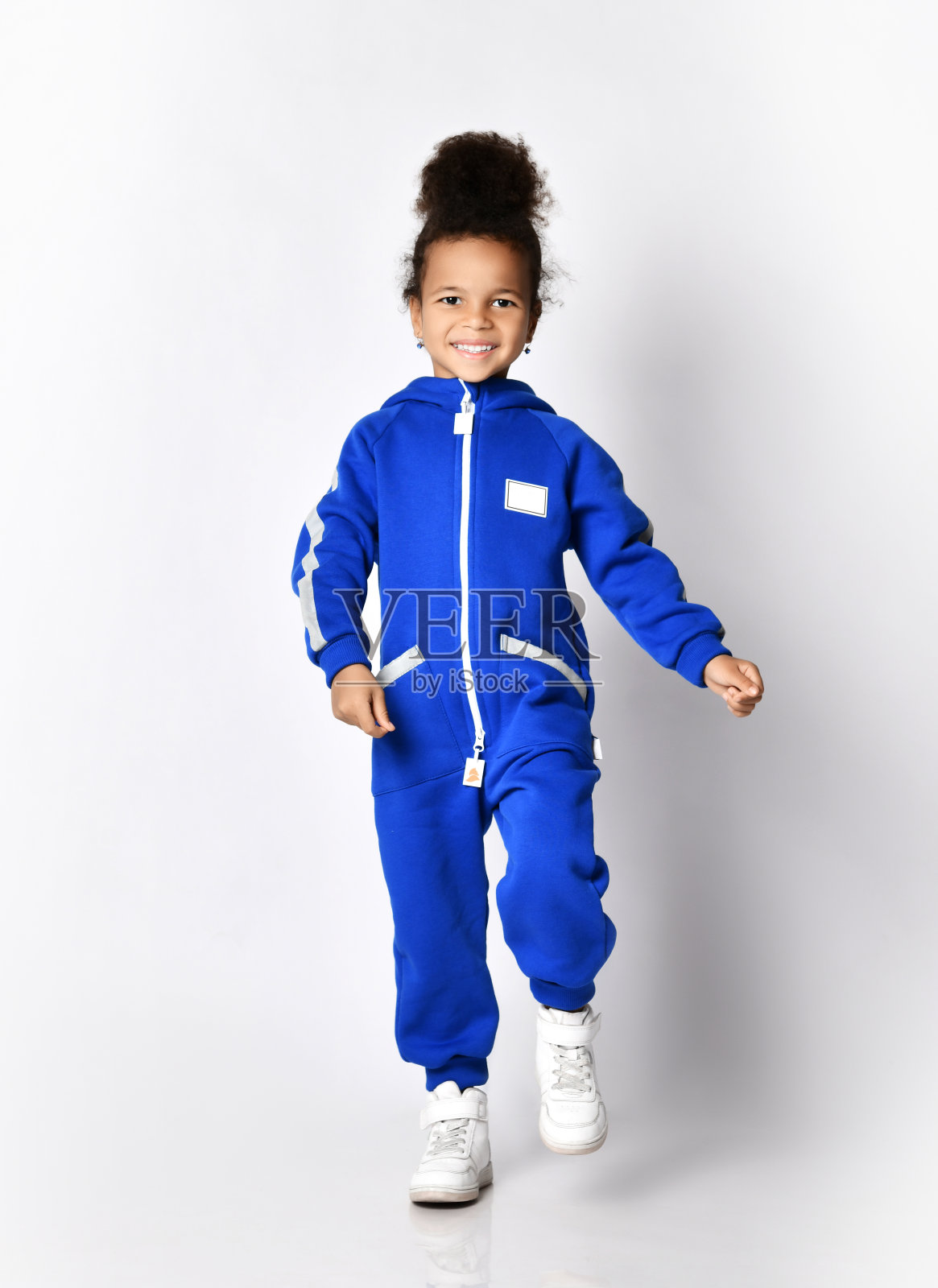 快乐的运动健康的深色皮肤的小女孩在运动做走向相机，向我们走来照片摄影图片