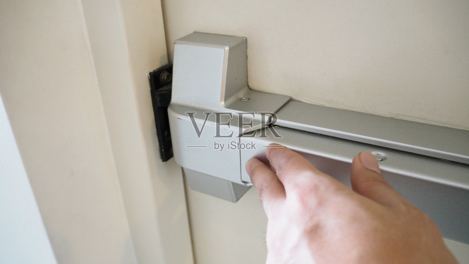 用于紧急疏散的消防出口的防火门把手。照片摄影图片