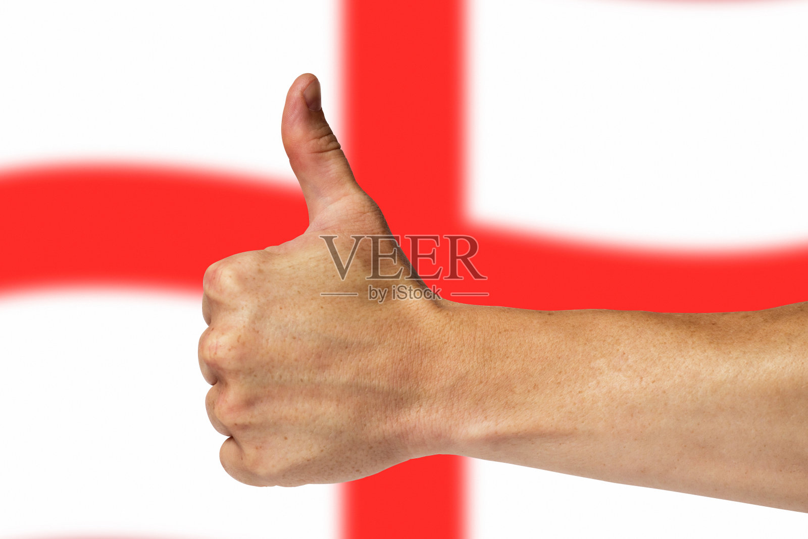 在英国国旗的背景上竖起大拇指照片摄影图片