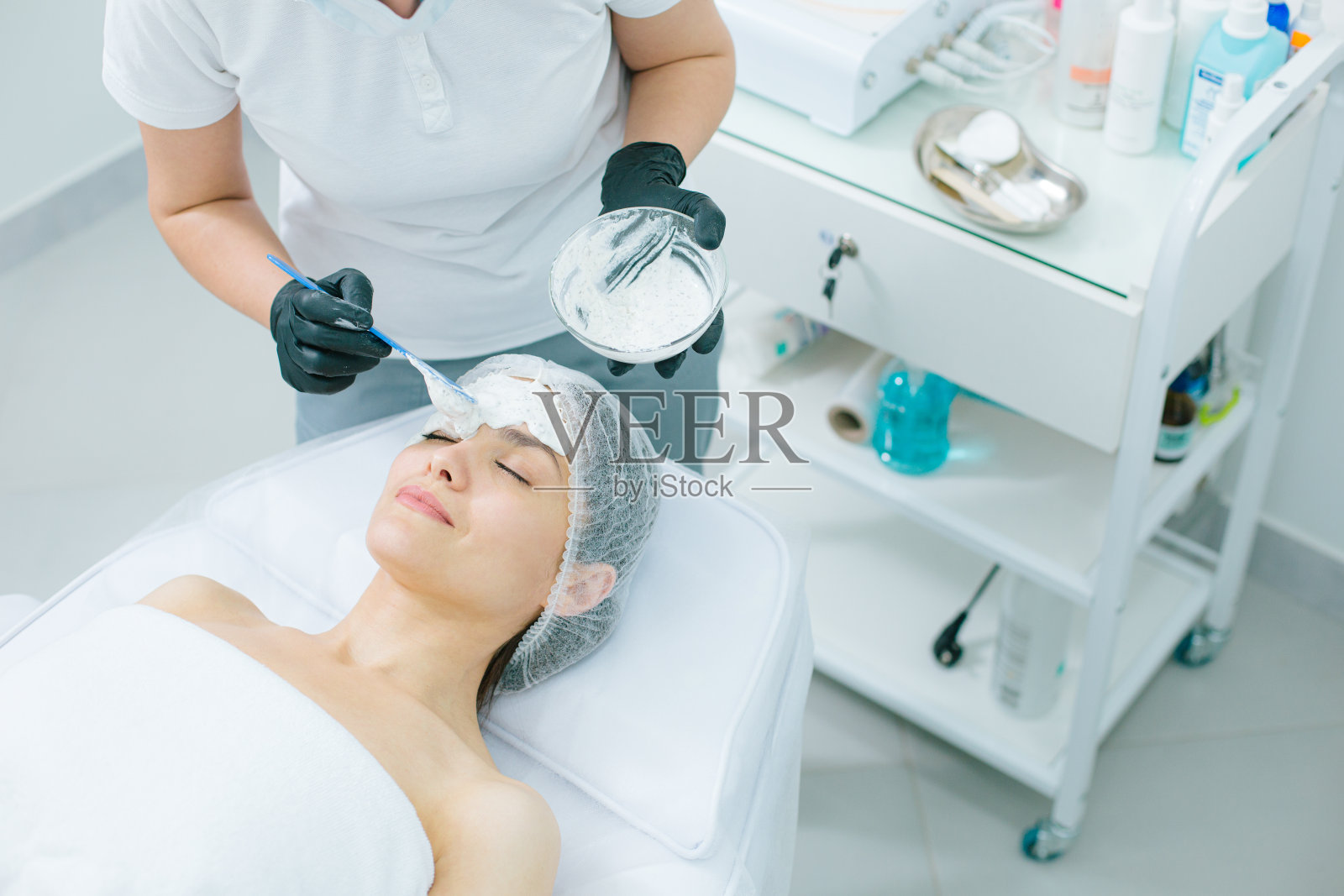 一碗海藻酸盐面膜在专业美容师手中照片摄影图片