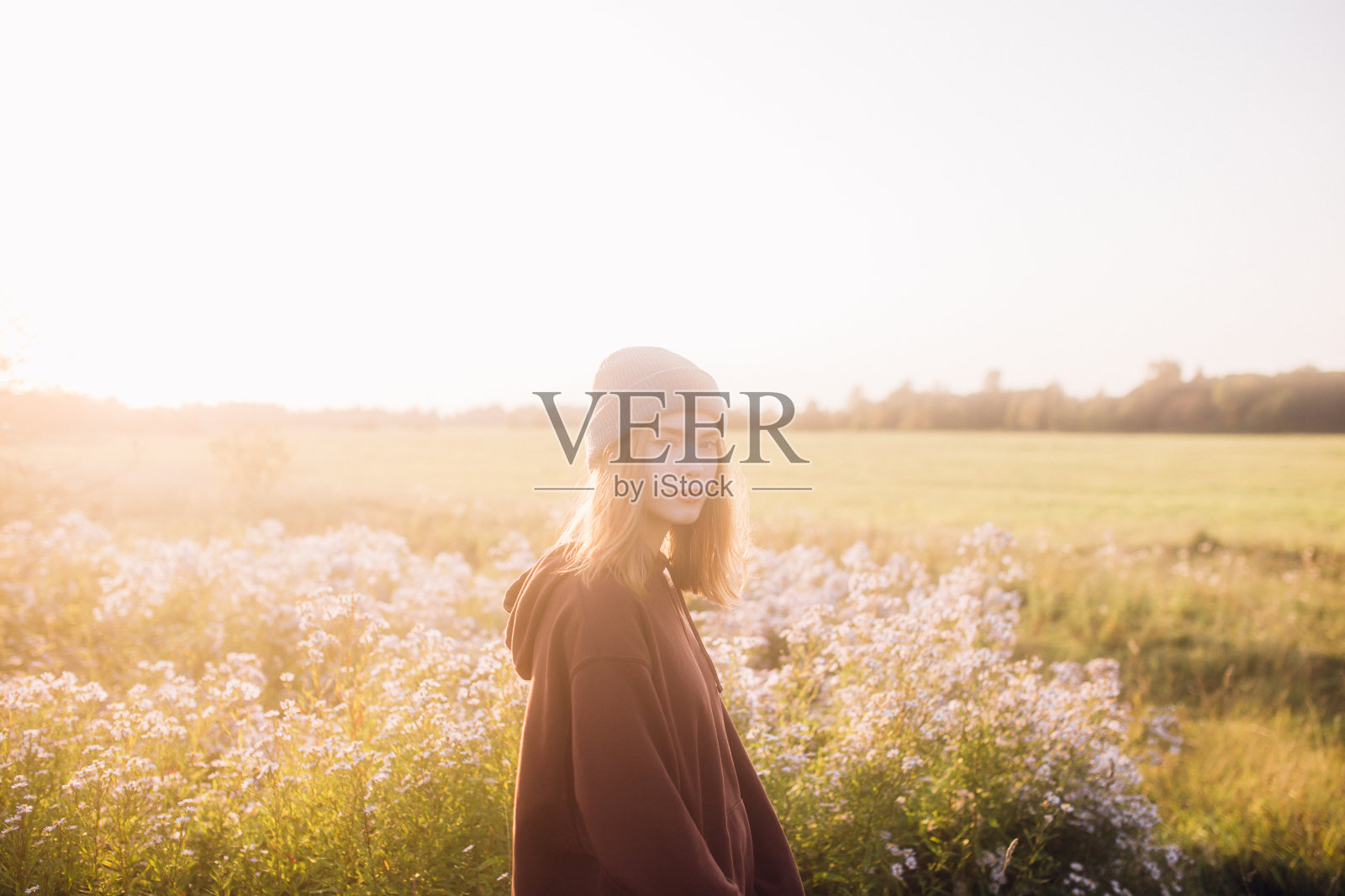 年轻女子站在草地上照片摄影图片