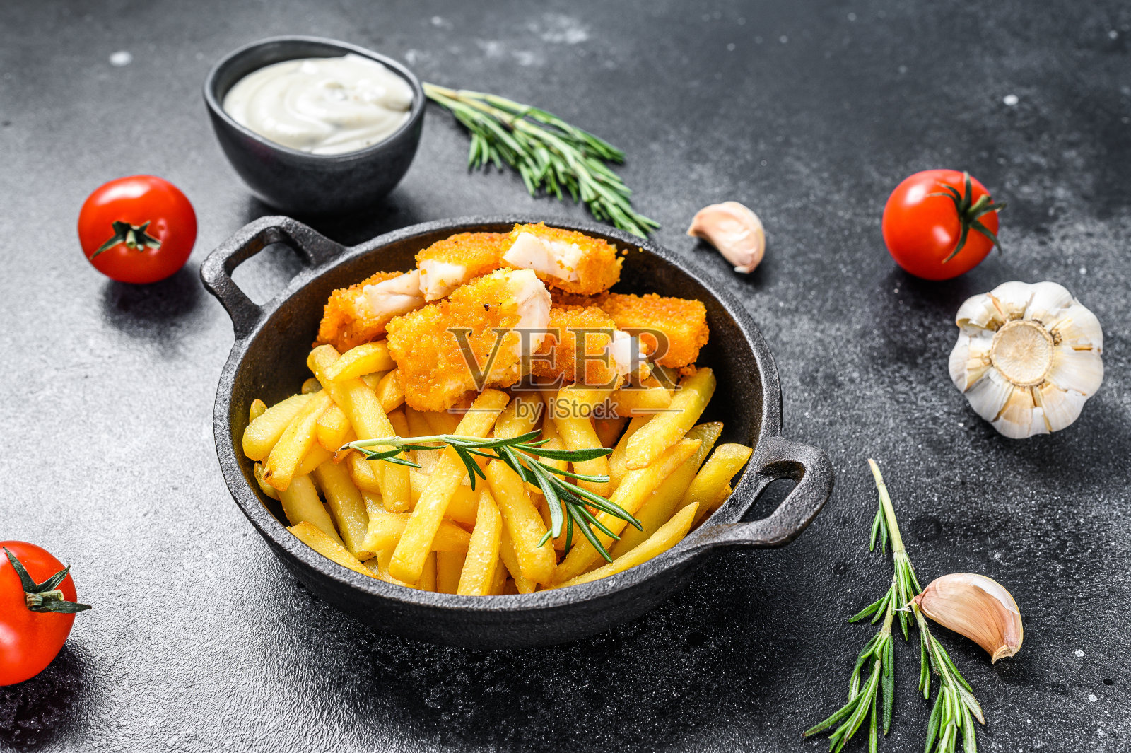 炸鱼薯条，英国快餐配塔塔酱。黑色背景。俯视图照片摄影图片