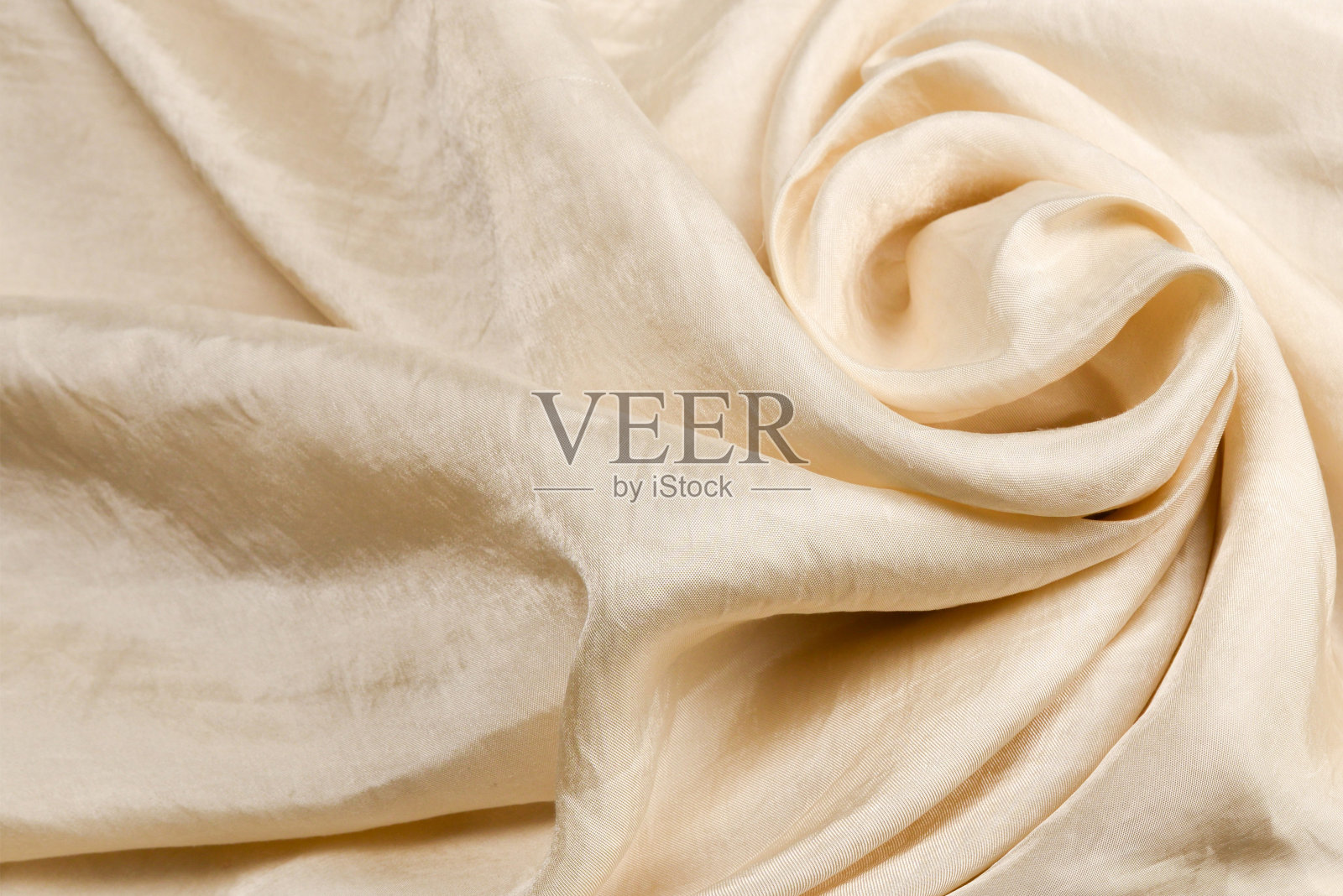 柔软光滑的米色丝质面料背景。面料质地。照片摄影图片