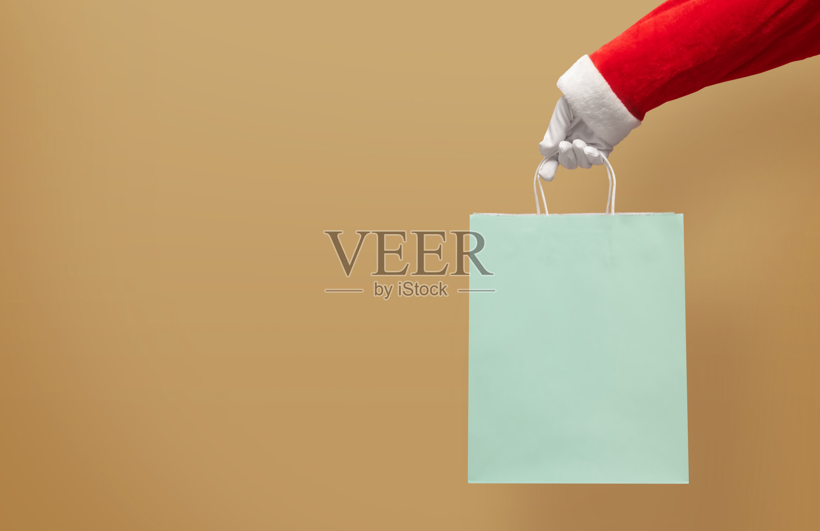 圣诞老人手拿蓝色购物纸袋照片摄影图片