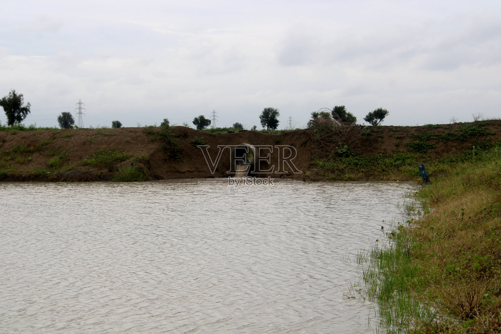 收集雨水的农场坑。照片摄影图片