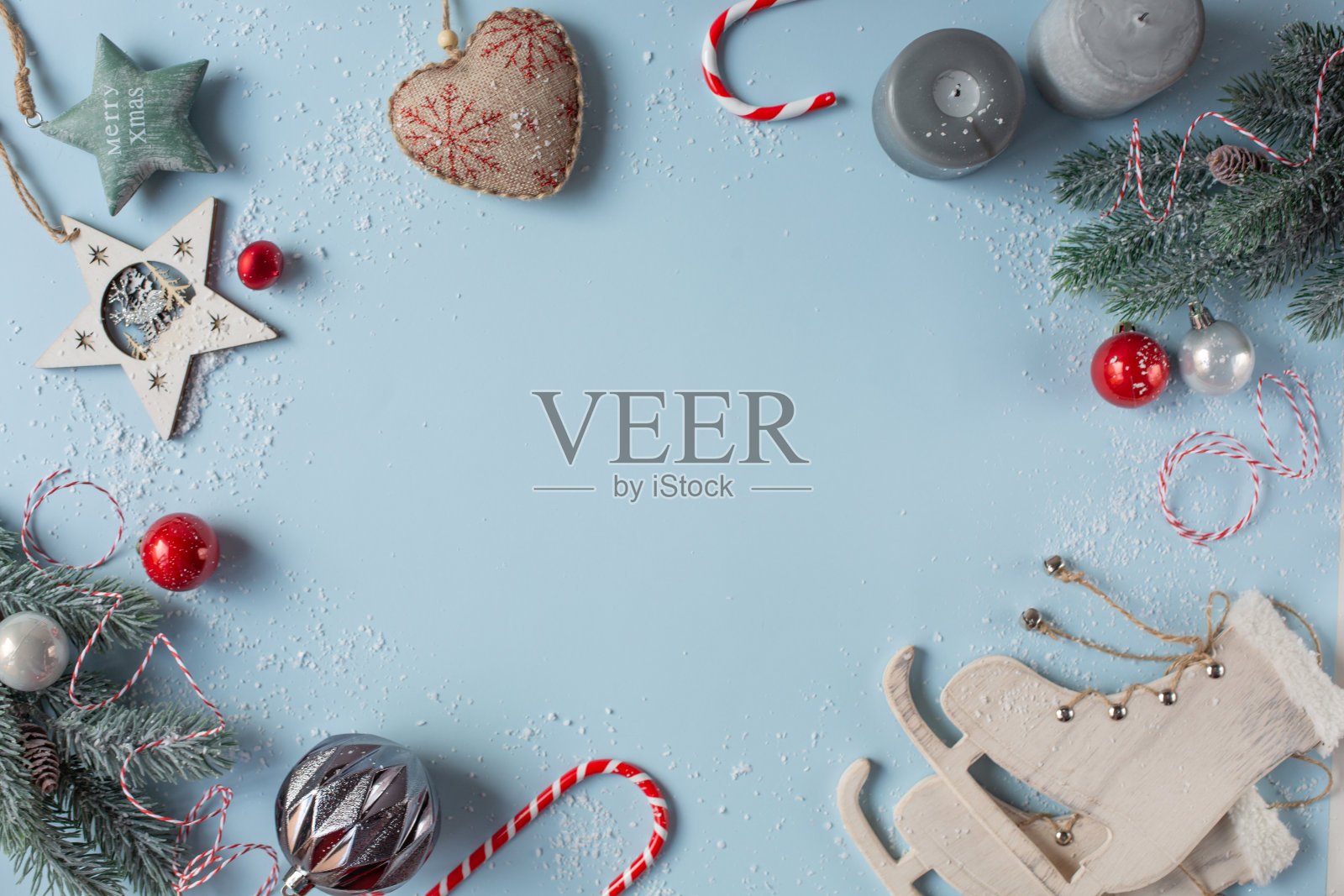 一组圣诞装饰位于图像的周边是浅蓝色的背景。照片摄影图片