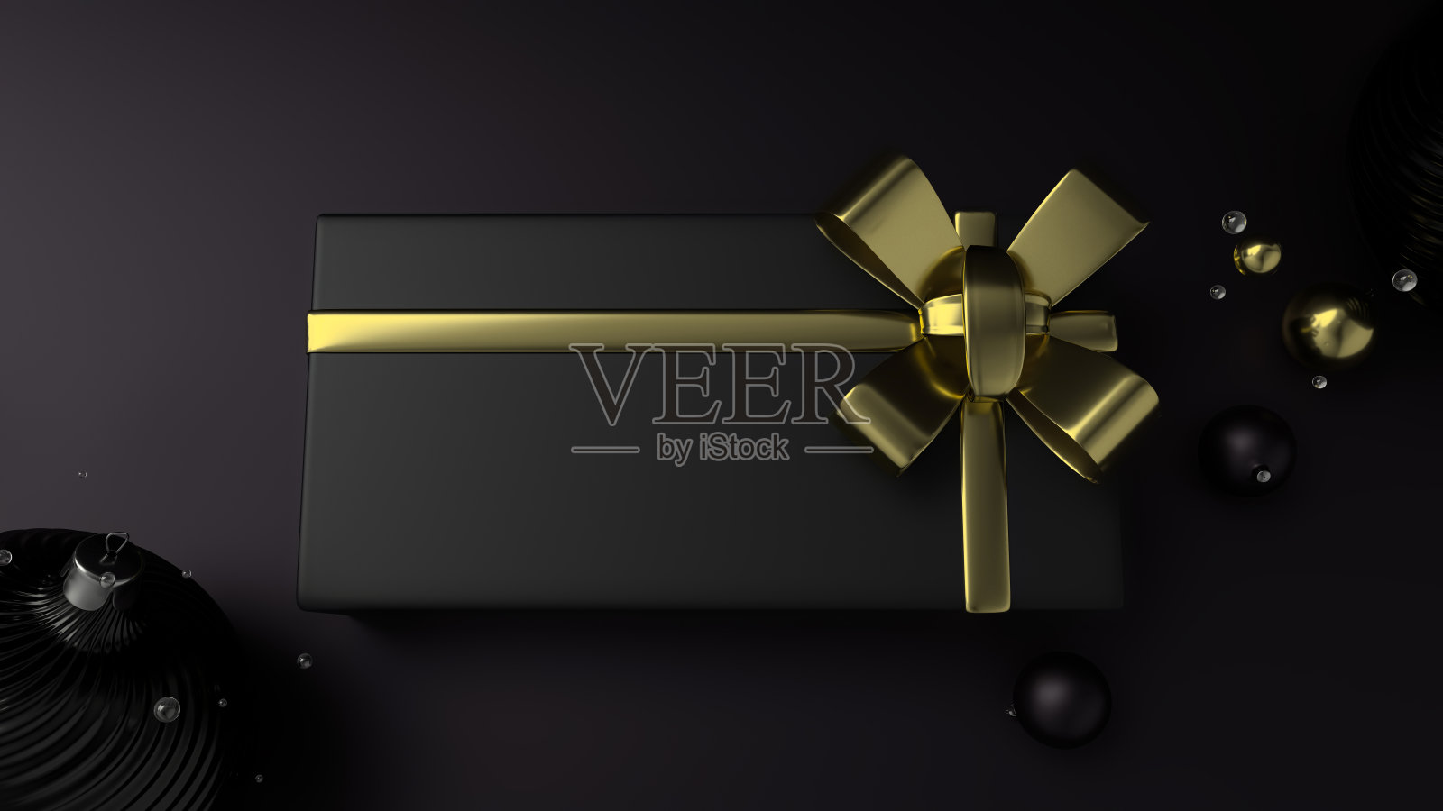 圣诞礼盒配有金色丝带，黑色平底色。照片摄影图片