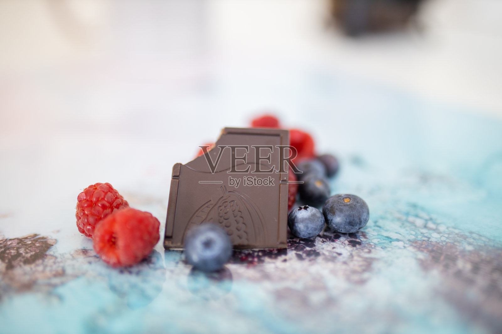 彩色的餐垫上放着咬过的巧克力和浆果照片摄影图片