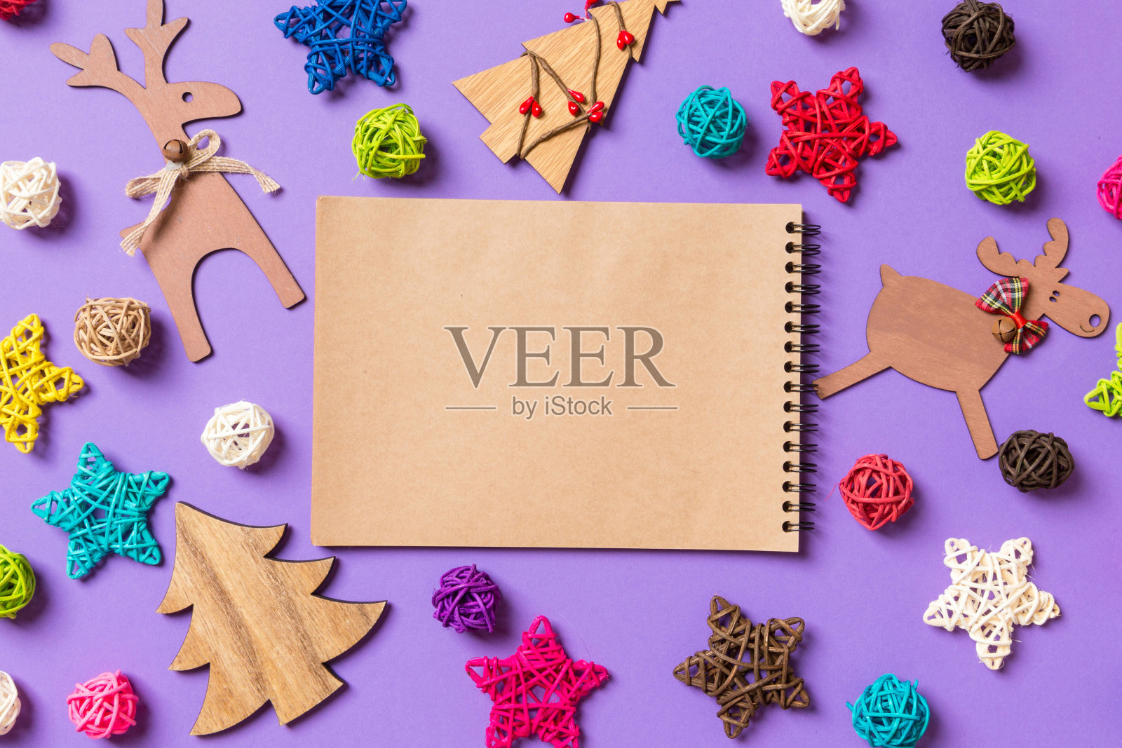 俯视角度：紫色背景上的新年装饰品，节日星星和彩球，圣诞节概念照片摄影图片