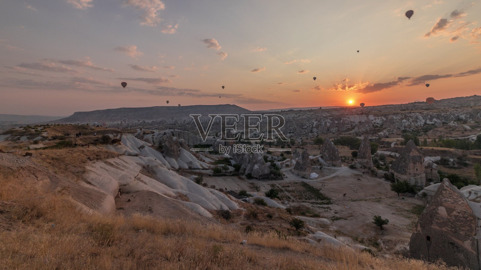 土耳其卡帕多西亚，美丽的日出和彩色的热气球起飞，在晴朗的天空中飞行照片摄影图片