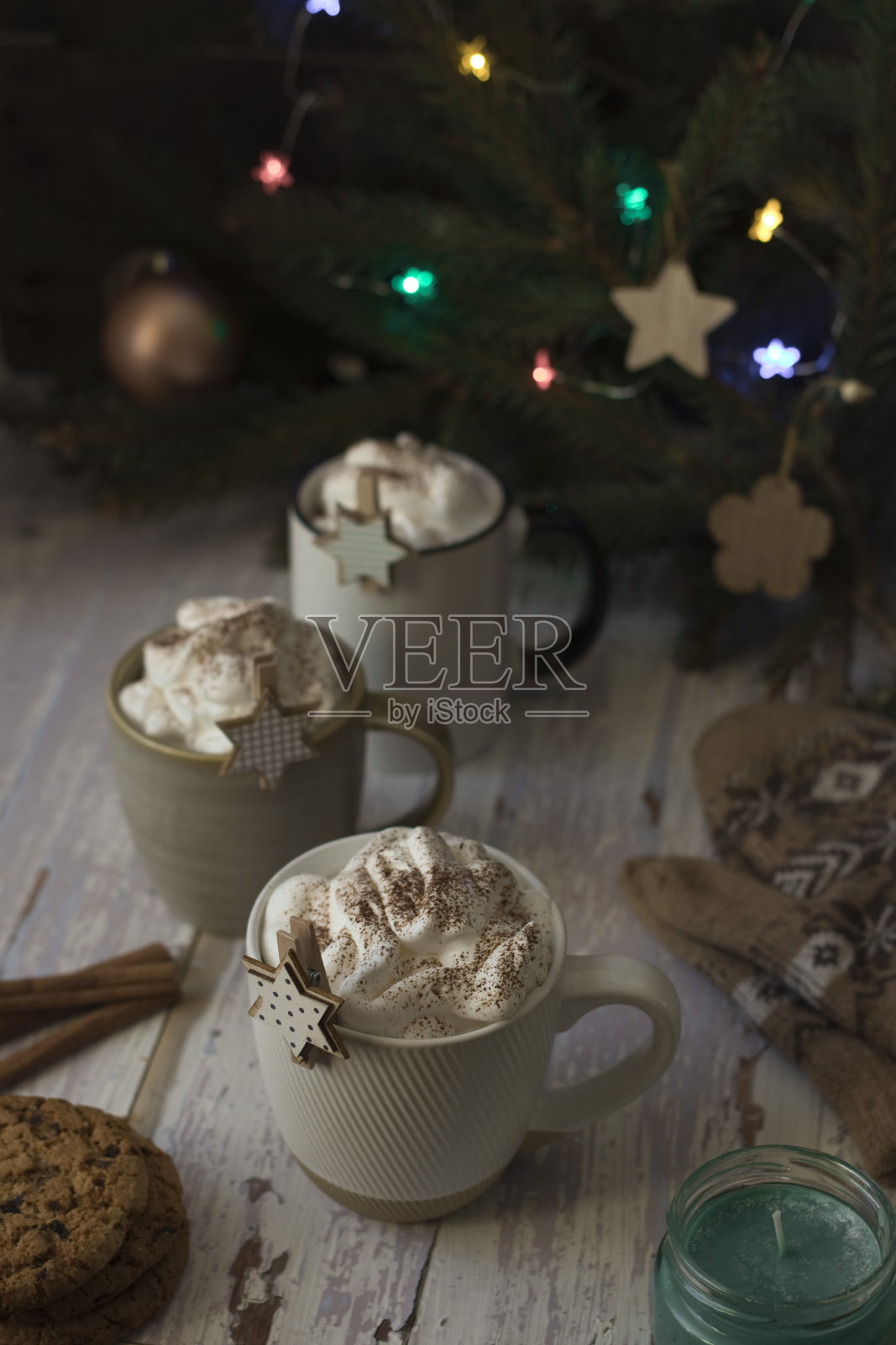 三杯热巧克力和鲜奶油放在质朴的桌子上照片摄影图片