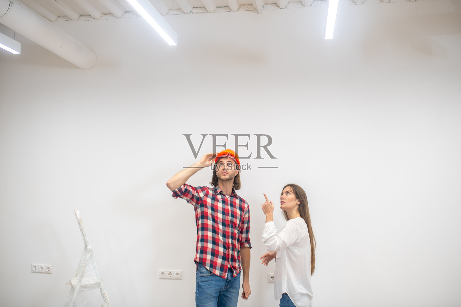 女采购员与建筑工人讨论细节照片摄影图片